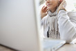 Older woman listening to headphones in laptop