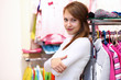 Young woman inside a store buying clothes