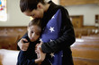 Mother and daughter hugging at military funeral