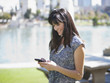 Businesswoman using cell phone outdoors