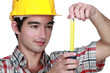 Builder holding tape measure