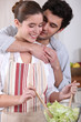 Couple making salad in the kitchen