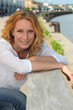 Portrait of a woman strolling by the quay