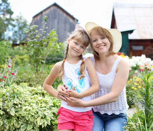 Photo: Mother and daughter gardening together Mother and daughter gardening together