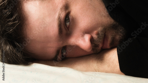 Photo: Attractive man lying on a bad Attractive man lying on a bad