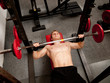 Man exercising his arm muscles by lifting two dumbell free weigh