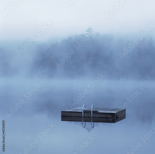 Photo: Wooden dock floating in still lake Wooden dock floating in still lake