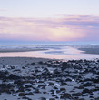Rocks littering sandy beach