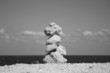 Astone stack against sea and blue sky
