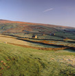 Houses and stone walls in rural landscape