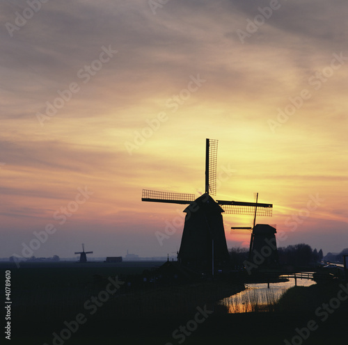 Photo: Silhouette of windmills in rural landscape Silhouette of windmills in rural landscape