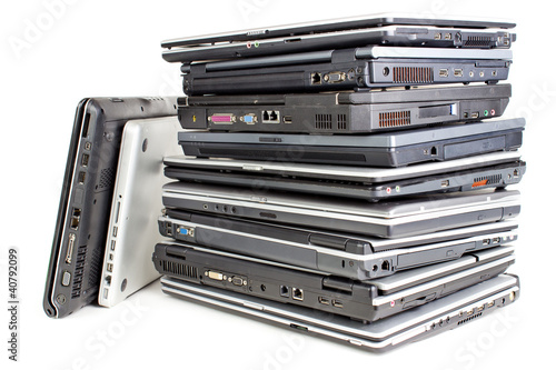 Photo: Pile of used laptops, white background Pile of used laptops, white background