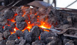 Forge with hot flaring coal