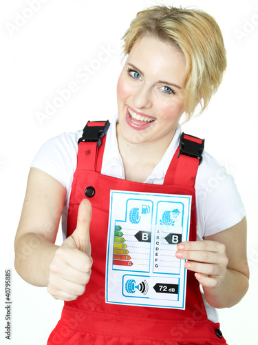 Photo: Apprentice shows thump up for tire label on white backround Apprentice shows thump up for tire label on white backround