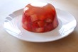 Jelly with fresh strawberries on a white dish Jelly with fresh strawberries on a white dish