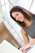 Portrait of smiling student girl working on laptop
