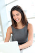 Portrait of smiling student girl working on laptop