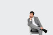 canvas print picture - Businessman sitting on chair on grey background