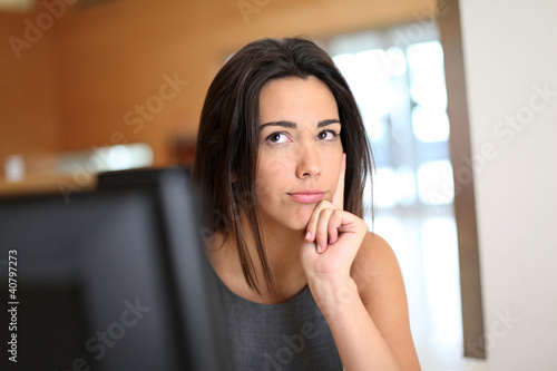 Photo: Office worker with interrogative look on her face Office worker with interrogative look on her face