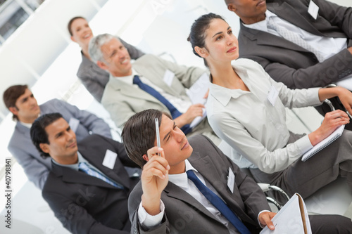 Photo: Man asks question at business meeting Man asks question at business meeting