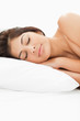 A woman sleeping on the bed with her head resting on the pillow,