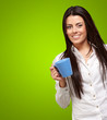 young girl holding cup over green background