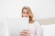 Low angle shot, woman looking at tablet pc