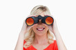 Photo: Blonde woman looking through binoculars Blonde woman looking through binoculars