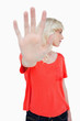 Young woman making the stop sign with hand while leaning her hea