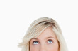 Upper part of the face of a blonde woman looking up