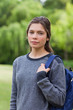 Young relaxed girl looking straight at the camera while standing