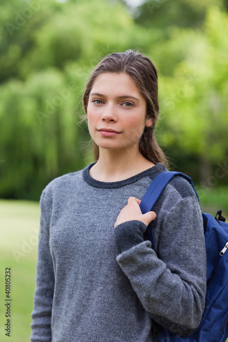 Photo: Young relaxed girl looking straight at the camera while standing Young relaxed girl looking straight at the camera while standing