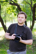 Middle age man with professional reflex camera on nature