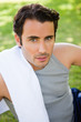 Man looking upwards with a towel resting on his shoulder