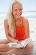 Young blonde woman looking at the camera while smiling and readi