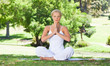 Woman on the grass doing yoga exercises