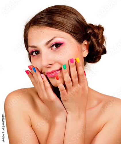 Photo: Beautiful sweet girl with multi-colored nails and makeup Beautiful sweet girl with multi-colored nails and makeup