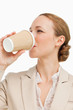 canvas print picture - Businesswoman in a suit drinking a takeaway coffee