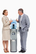 canvas print picture - People in suit talking next to the water dispenser