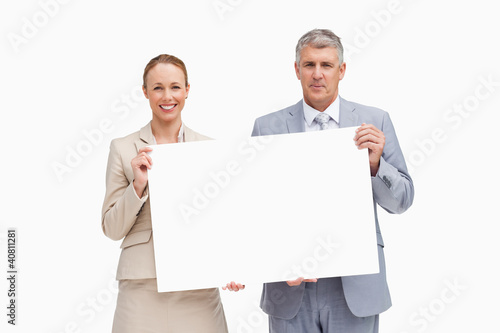 Foto: Business people holding a poster Business people holding a poster