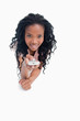 Photo: A smiling young girl is pointing a television remote at the came A smiling young girl is pointing a television remote at the came
