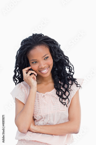 Photo: A smiling young woman is talking on her mobile phone A smiling young woman is talking on her mobile phone