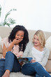 Photo: Two surprised women reading a magazine Two surprised women reading a magazine