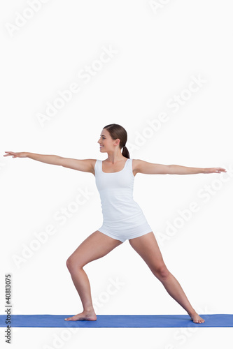 Photo: Smiling woman practicing yoga on a mat Smiling woman practicing yoga on a mat