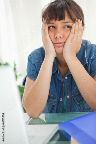 Photo: Female student bored looking up Female student bored looking up