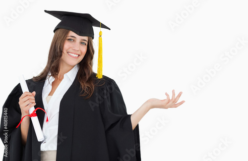 Photo: A woman with a hand out to her side as she smiles and looks at t A woman with a hand out to her side as she smiles and looks at t