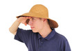 Foto: Young man with straw hat watching at the distance Young man with straw hat watching at the distance