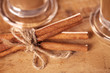 Cinnamon sticks tied up and coffee on wood