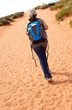 canvas print picture - Woman walking the desert