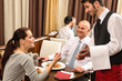 Business lunch waiter taking order at restaurant